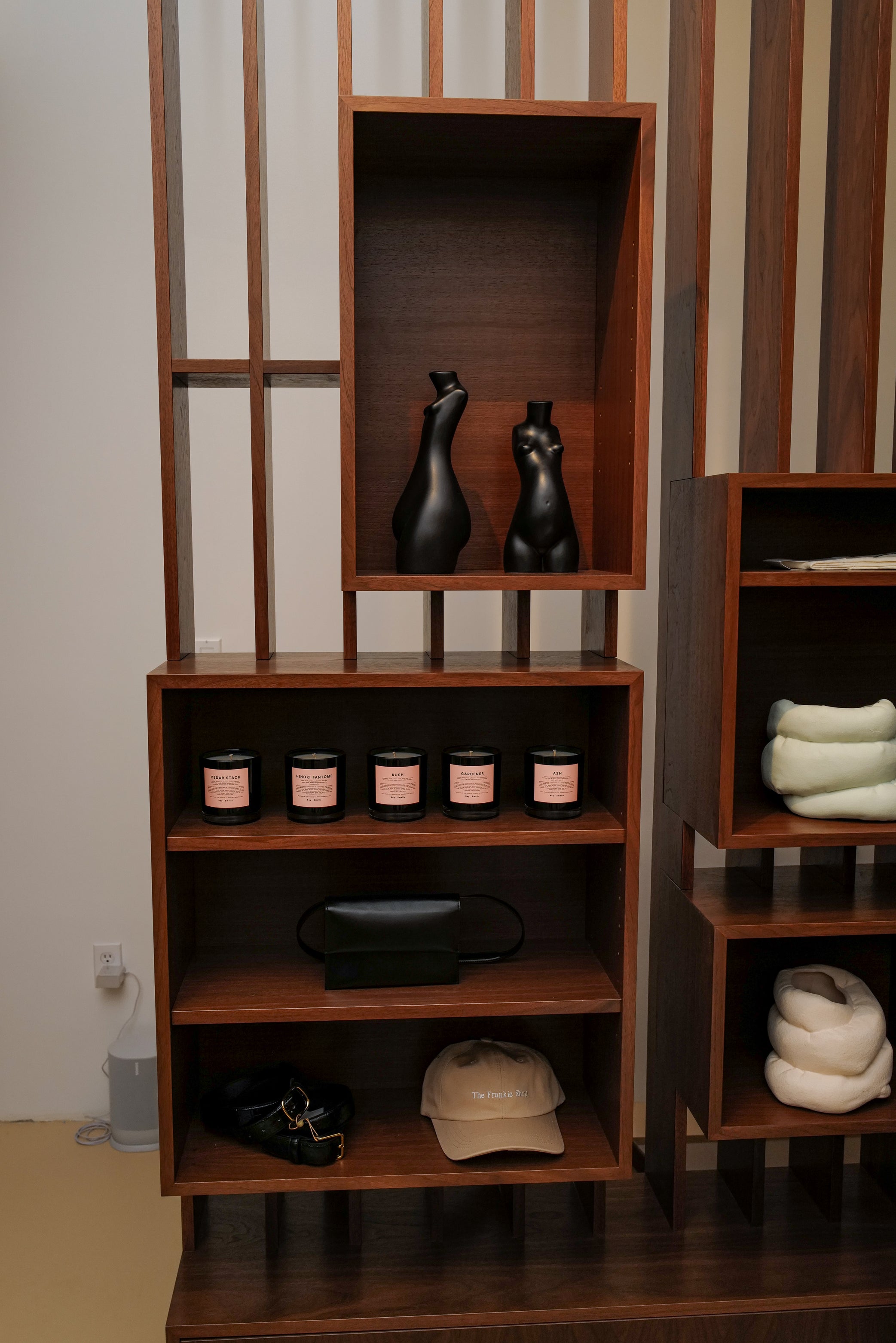 A cabinet inside the New York Frankie Shop store, filled with candles, hats and sculptures.