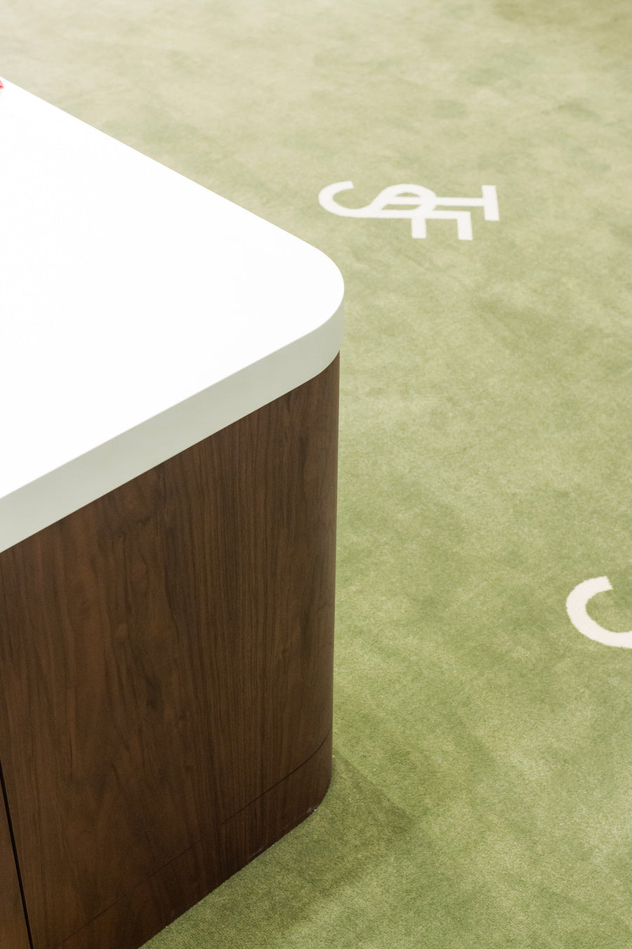 Close up of the Frankie Shop green logo carpet inside the Galeries Lafayette photographed by Chis Rhodes.