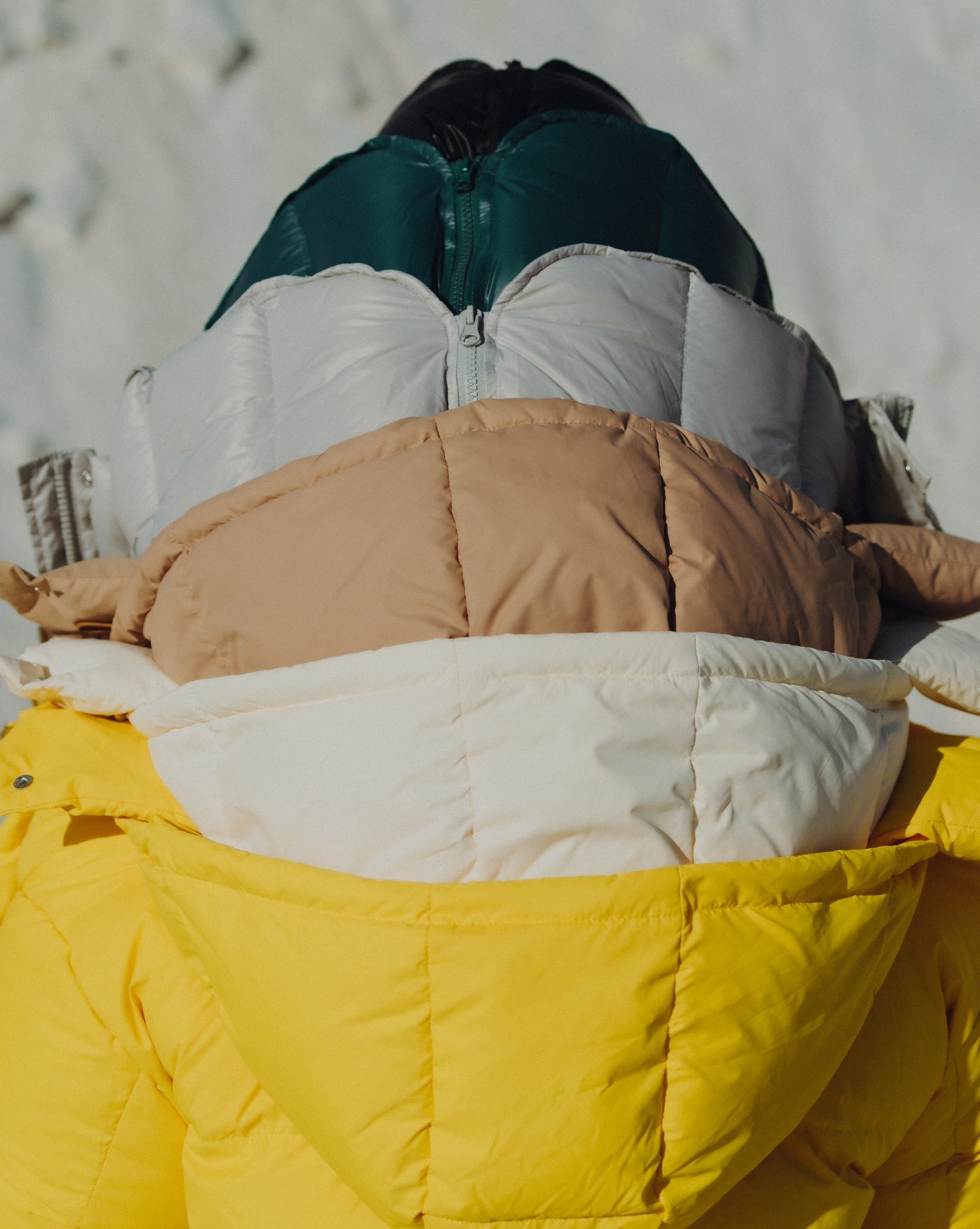 Model wearing 5 of the Val puffer jacket all in different colors. Photographed by Charlotte Lapalus