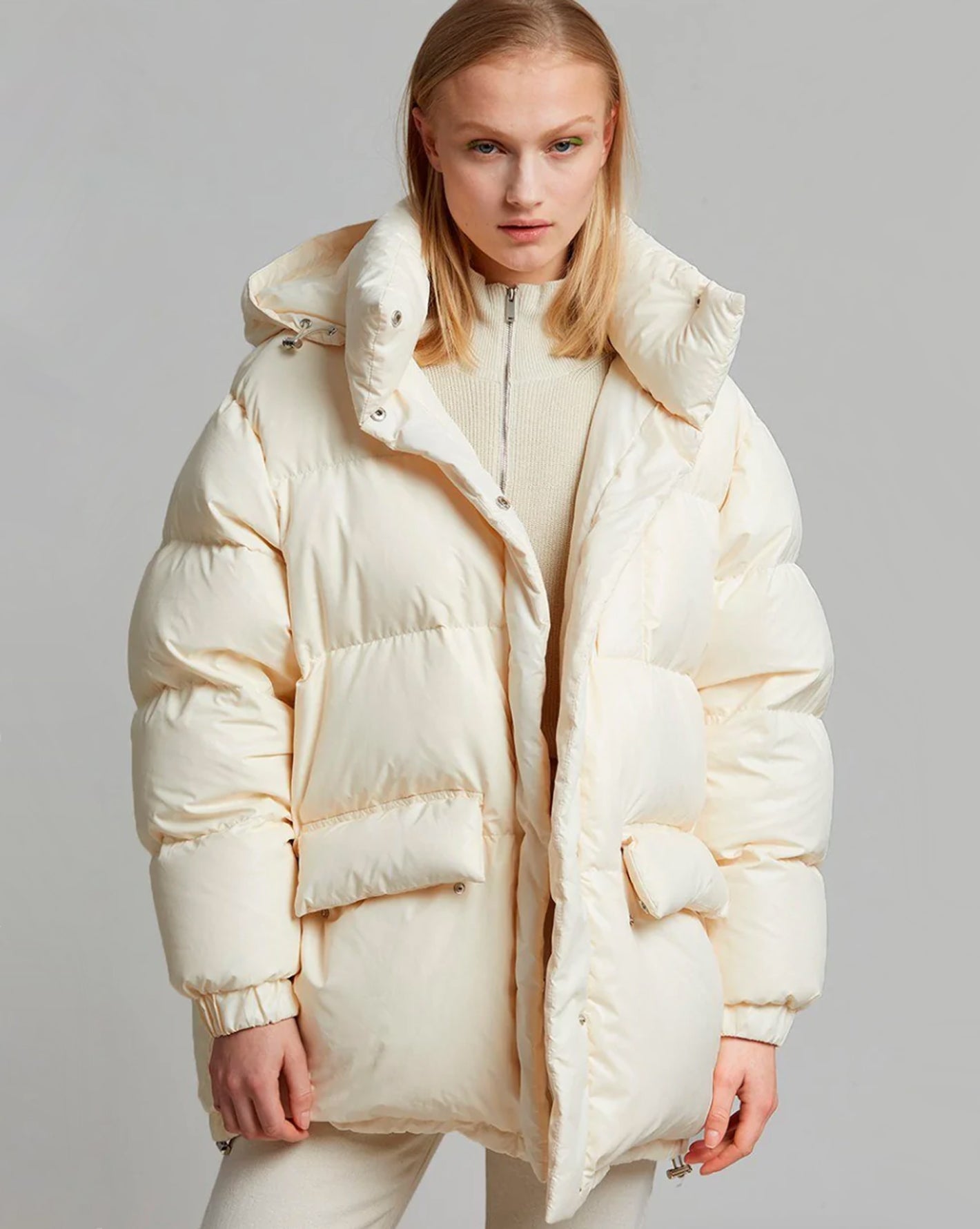 Female model wearing the Val jacket in cream.