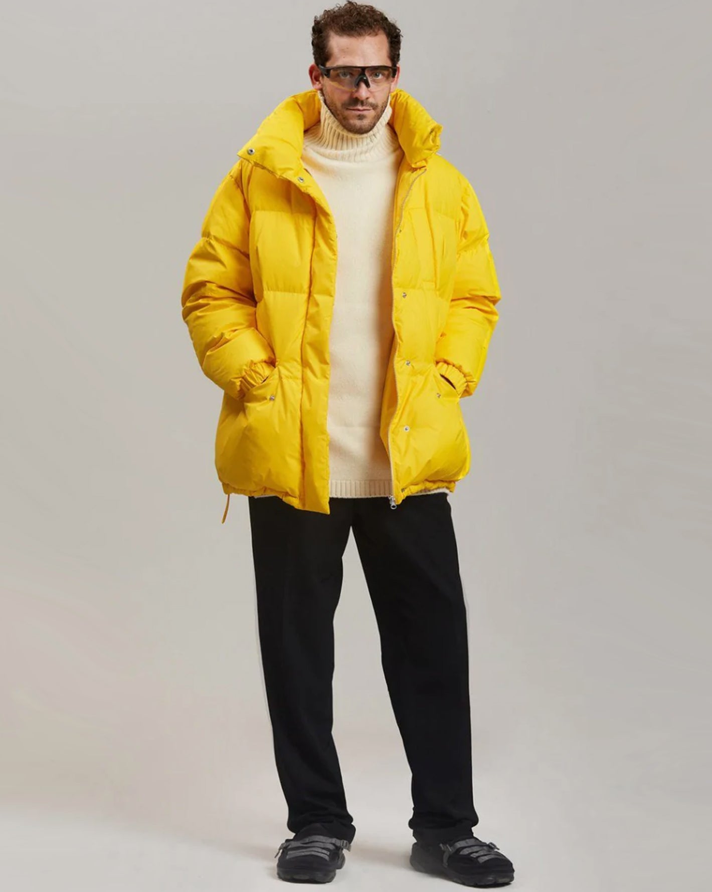 Male model wearing the yellow Val puffer jacket. 