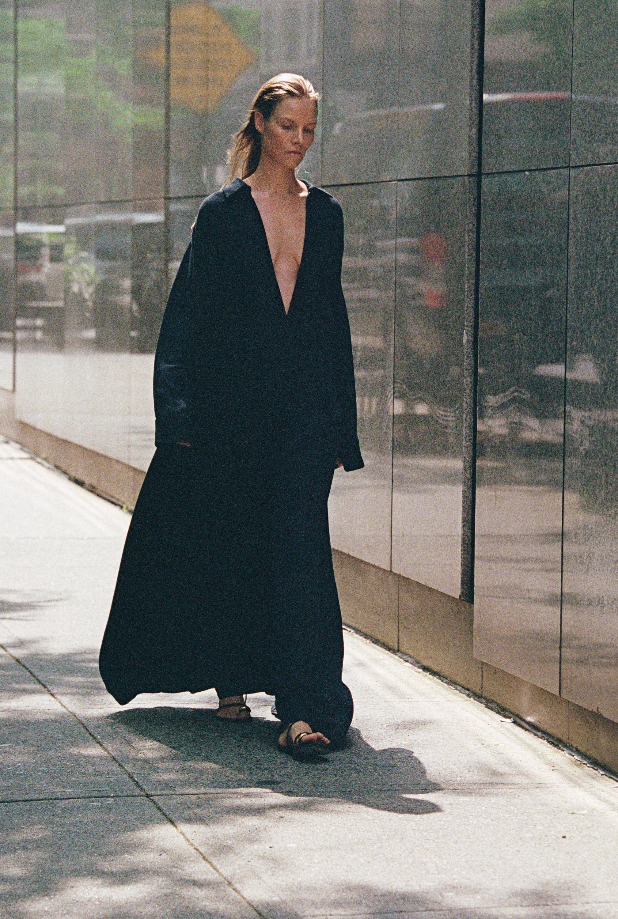 Women walking on the street in a black long dress 