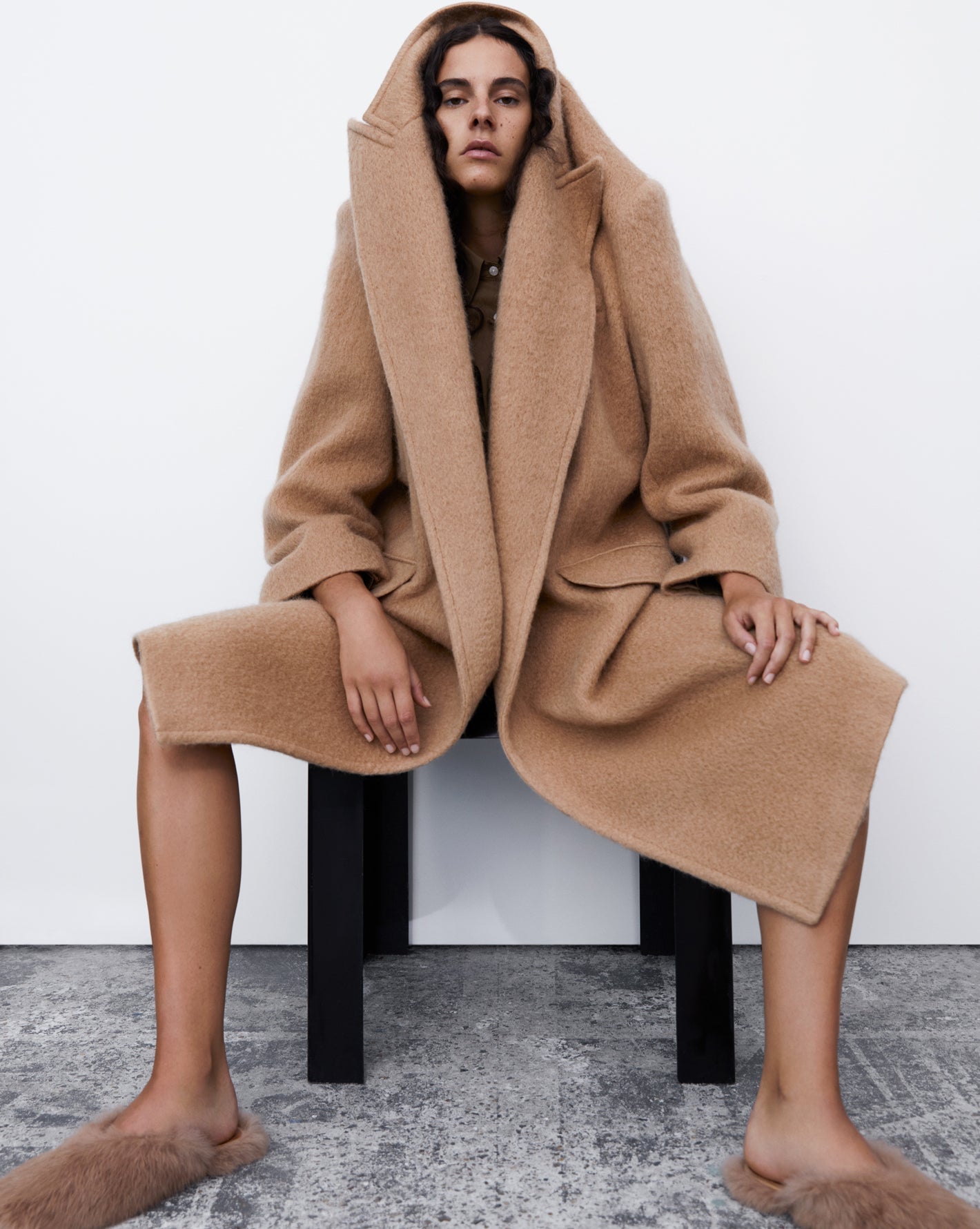 Model wearing a camel wool coat for the Frankie Shop FW21 campaign with Suzanne Koller. 