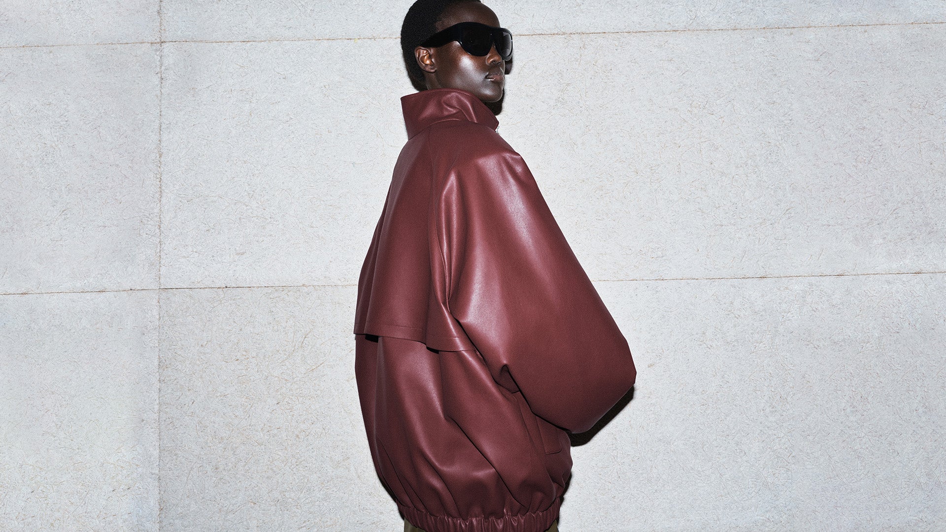 The Frankie Shop winter editorial by Sarah Blais. Model wearing a large red leather jacket and sunglasses.