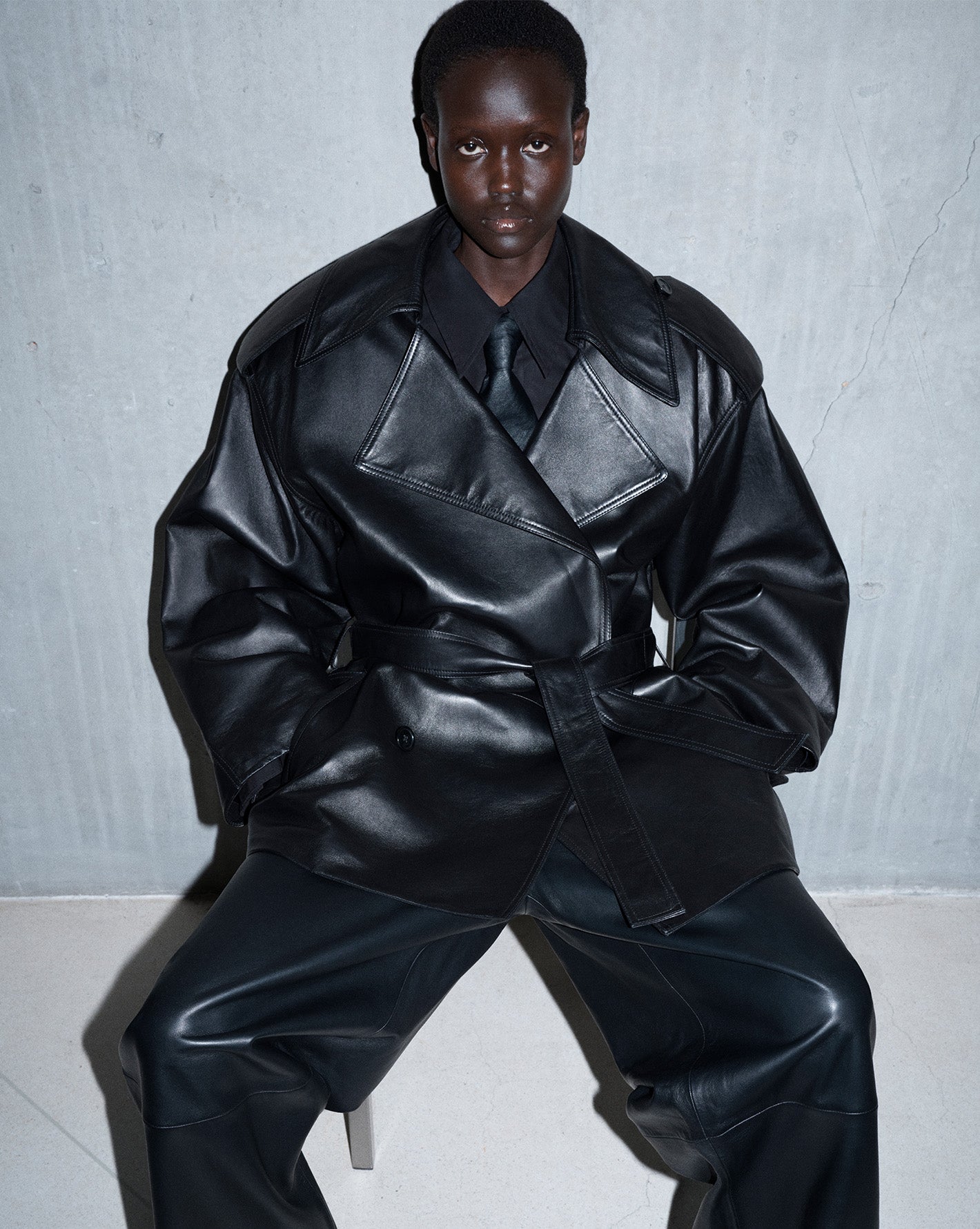 The Frankie Shop model wearing a leather jacket and leather pants.
