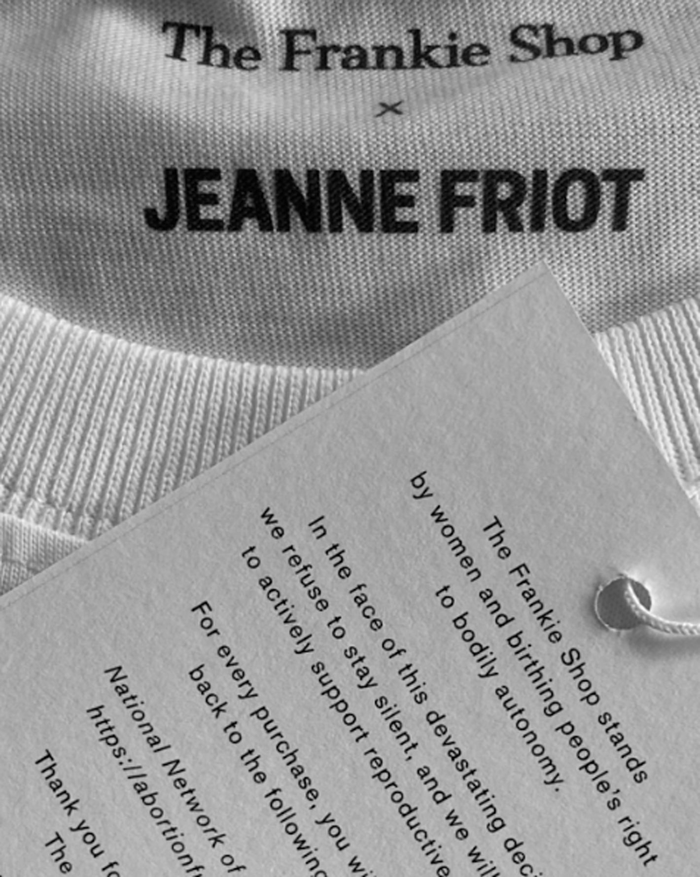 Close up of the t-shirt tag that says "The Frankie Shop" x Jeanne Friot. 